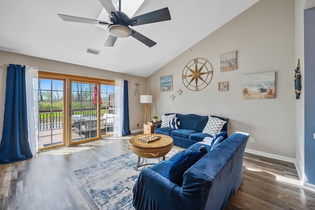 living area with a ceiling fan, visible vents, wood finished floors, baseboards, and lofted ceiling