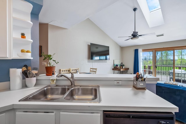 kitchen with light countertops, open shelves, visible vents, and a sink