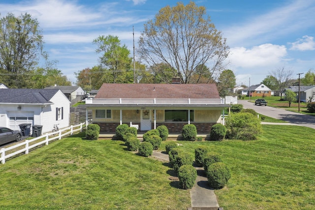 view of front of home with a porch, a front lawn, fence, and a residential view