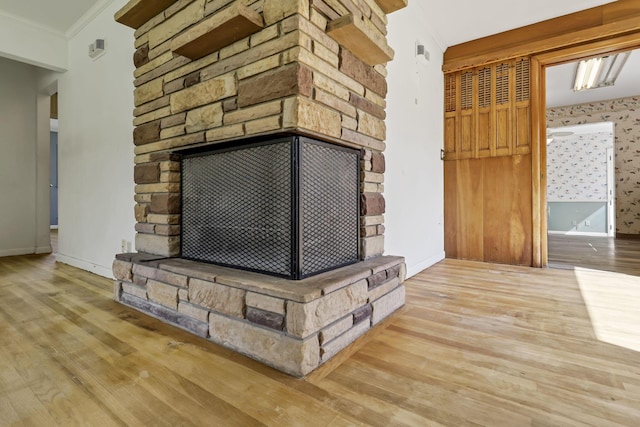interior details with baseboards, a fireplace, and wood finished floors