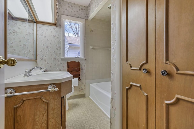 bathroom with vanity, shower / bathtub combination, tile patterned floors, and wallpapered walls