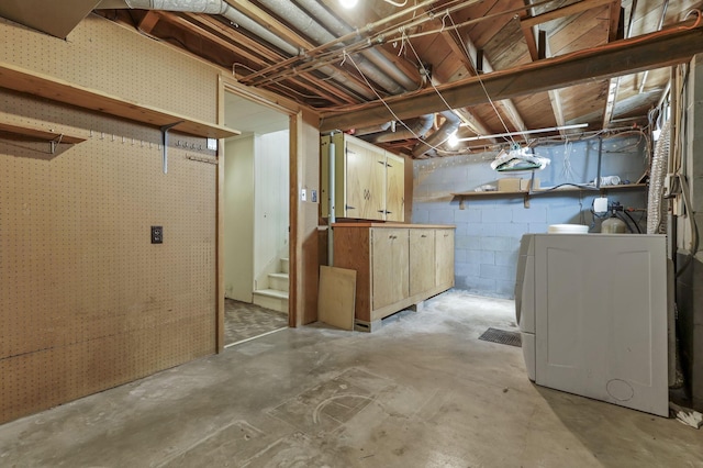 unfinished basement featuring washer / clothes dryer and stairway