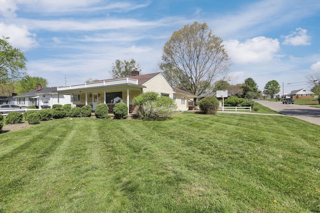 view of front of home with a porch and a front yard