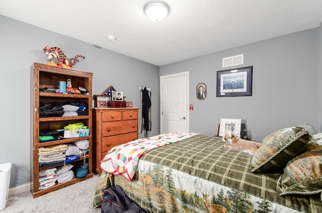 bedroom with baseboards, carpet, and visible vents