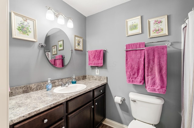 bathroom featuring vanity and toilet