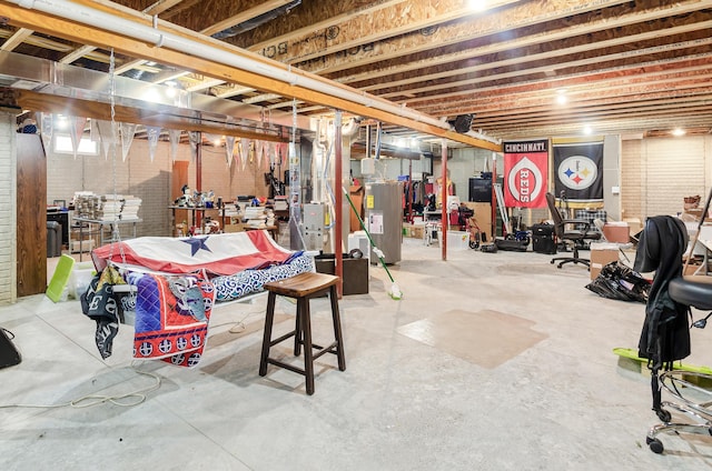 unfinished below grade area with brick wall and electric water heater