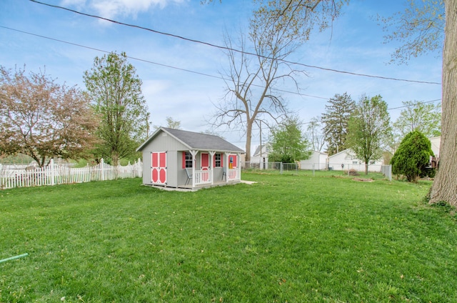 view of yard with a fenced backyard, an outbuilding, and a shed