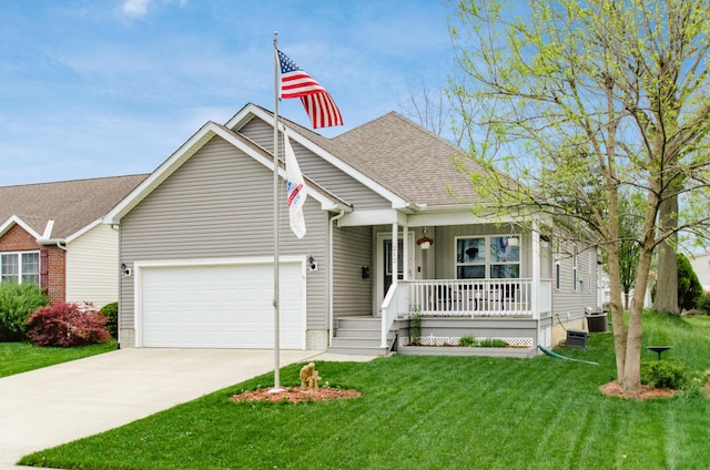 view of front facade featuring a front lawn, covered porch, a shingled roof, an attached garage, and driveway