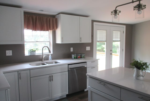 kitchen featuring white cabinets, a sink, light countertops, french doors, and stainless steel dishwasher