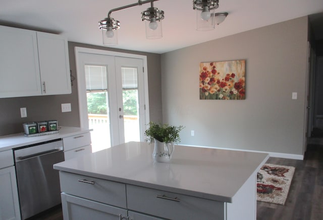 kitchen featuring a kitchen island, dark wood finished floors, dishwasher, light countertops, and white cabinetry