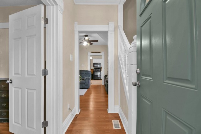 54 E Smiley Ave, Shelby, OH 44875 - hallway with baseboards, ornamental molding, wood finished floors, and visible vents