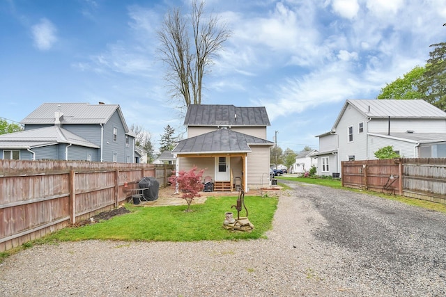 54 E Smiley Ave, Shelby, OH 44875 - back of house featuring a lawn, a standing seam roof, fence, and metal roof