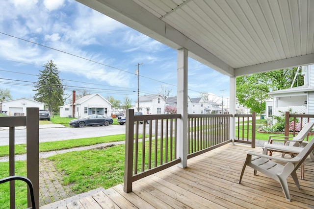 54 E Smiley Ave, Shelby, OH 44875 - wooden terrace with a porch, a lawn, and a residential view