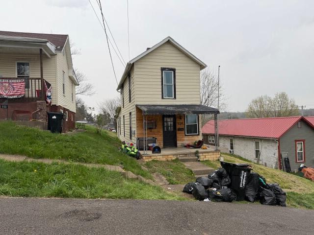 rear view of house with covered porch