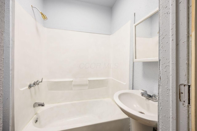 bathroom featuring a sink and shower / tub combination