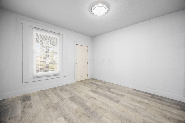 empty room with wood finished floors
