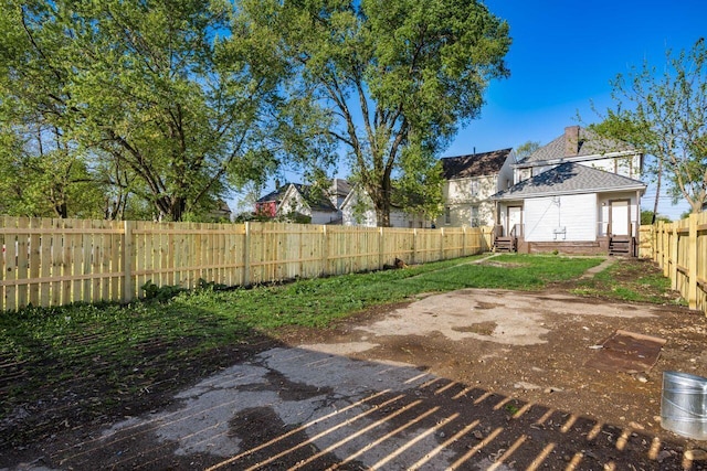 view of yard featuring a fenced backyard and entry steps