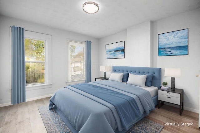 bedroom with baseboards and wood finished floors