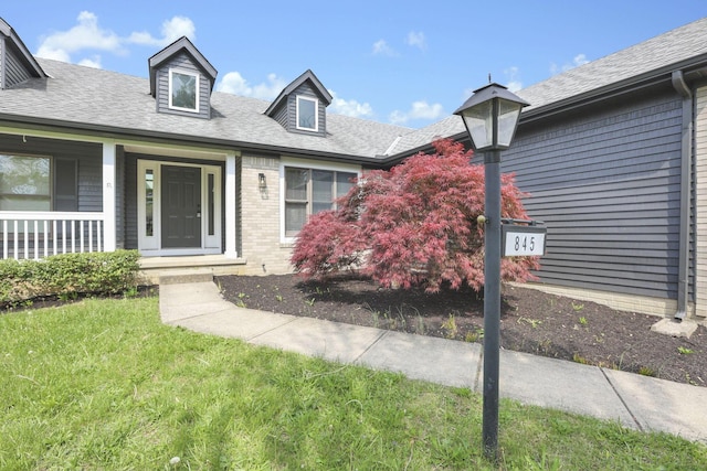 845 Mcnaughten Rd, Columbus, OH 43213 - view of front of property with a porch, roof with shingles, and a front yard