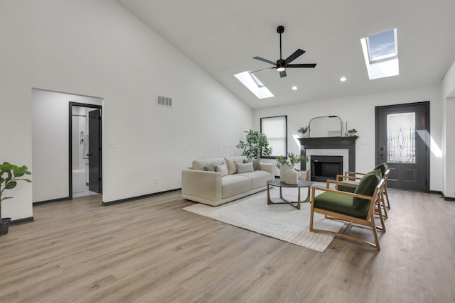 845 Mcnaughten Rd, Columbus, OH 43213 - living room with a fireplace, high vaulted ceiling, light wood-type flooring, a skylight, and visible vents