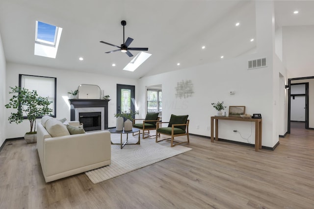 845 Mcnaughten Rd, Columbus, OH 43213 - living area with a skylight, high vaulted ceiling, a premium fireplace, and visible vents