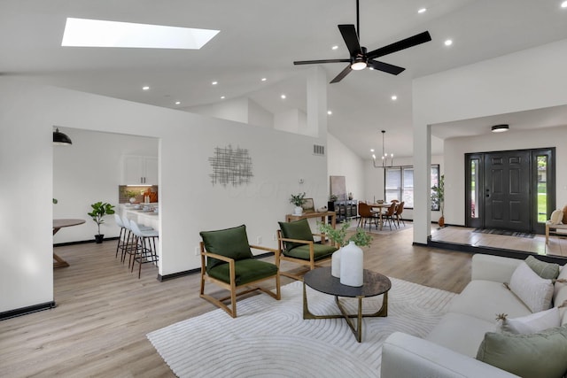 845 Mcnaughten Rd, Columbus, OH 43213 - living room featuring high vaulted ceiling, baseboards, light wood finished floors, a chandelier, and recessed lighting