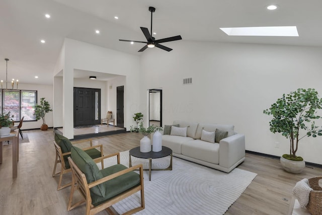 845 Mcnaughten Rd, Columbus, OH 43213 - living room with baseboards, ceiling fan with notable chandelier, light wood-style flooring, and visible vents