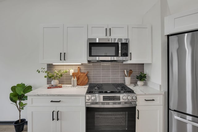 845 Mcnaughten Rd, Columbus, OH 43213 - kitchen featuring light stone counters, appliances with stainless steel finishes, backsplash, and white cabinets