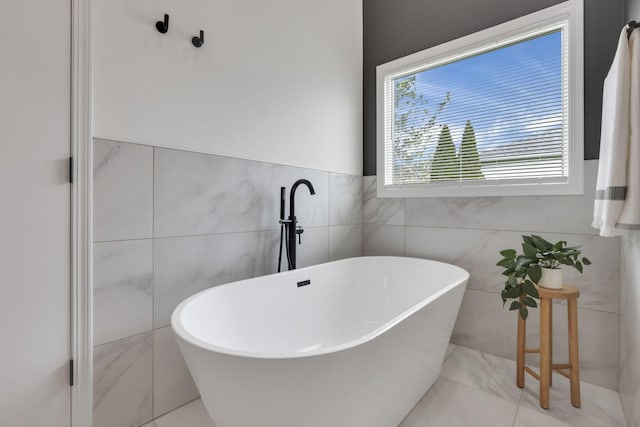 845 Mcnaughten Rd, Columbus, OH 43213 - bathroom with a freestanding bath and tile walls