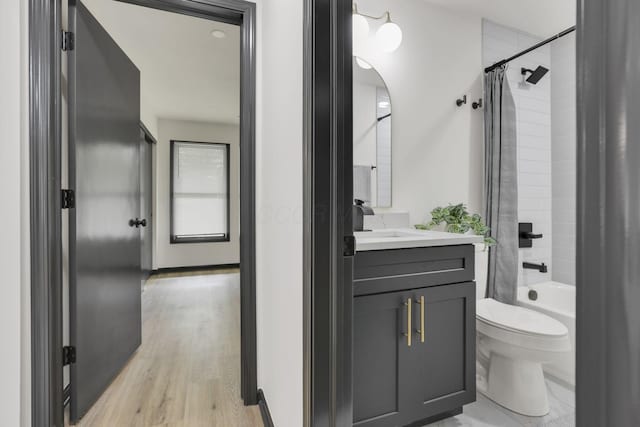 845 Mcnaughten Rd, Columbus, OH 43213 - full bathroom with vanity, shower / tub combo, wood finished floors, and toilet