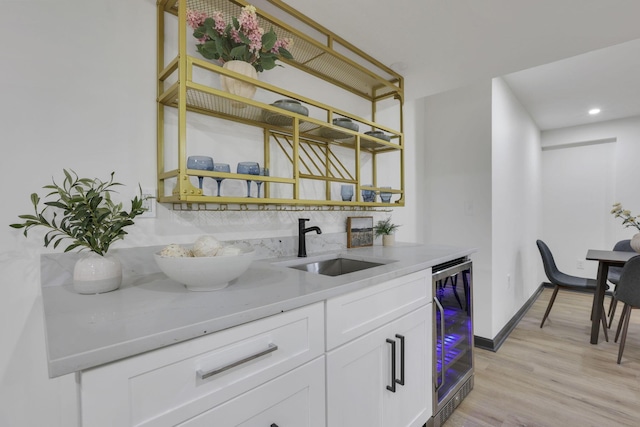 845 Mcnaughten Rd, Columbus, OH 43213 - bar with wine cooler, light wood-style floors, baseboards, recessed lighting, and a sink