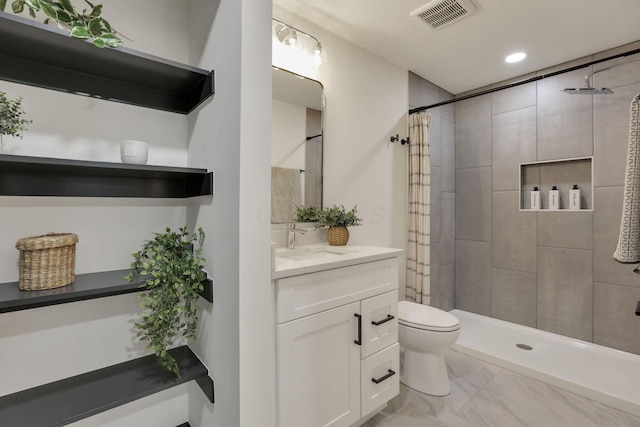 845 Mcnaughten Rd, Columbus, OH 43213 - bathroom with a tile shower, vanity, toilet, marble finish floor, and visible vents