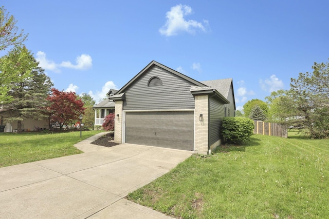 845 Mcnaughten Rd, Columbus, OH 43213 - view of front of property featuring fence, brick siding, a garage, a front yard, and concrete driveway