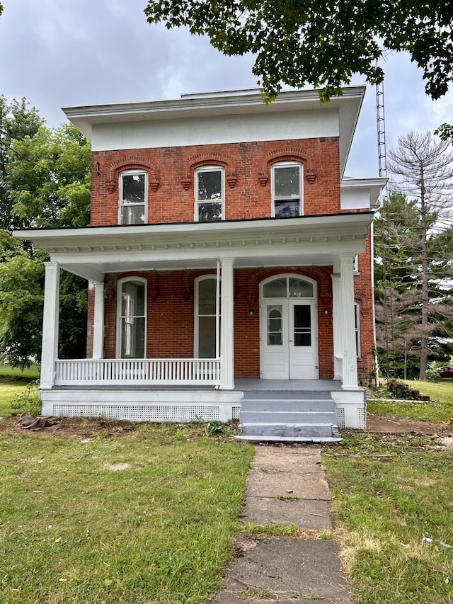 215 S Main St, Nevada, OH 44849 - view of front of house with brick siding, covered porch, and a front yard