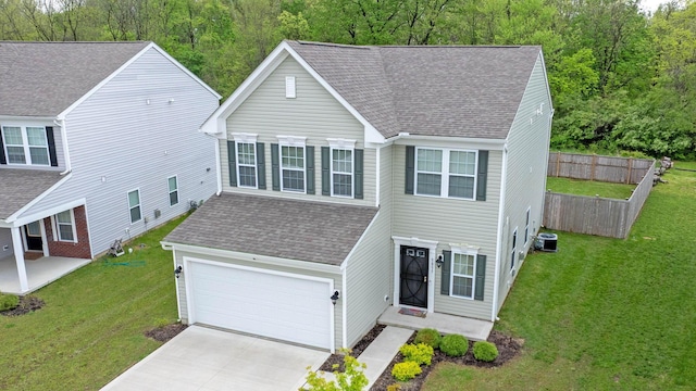 5837 Mouzon Dr, Columbus, OH 43232 - traditional home with concrete driveway, roof with shingles, fence, and a front lawn