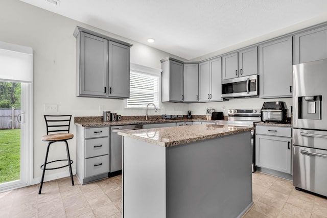 5837 Mouzon Dr, Columbus, OH 43232 - kitchen with a wealth of natural light, appliances with stainless steel finishes, and gray cabinetry