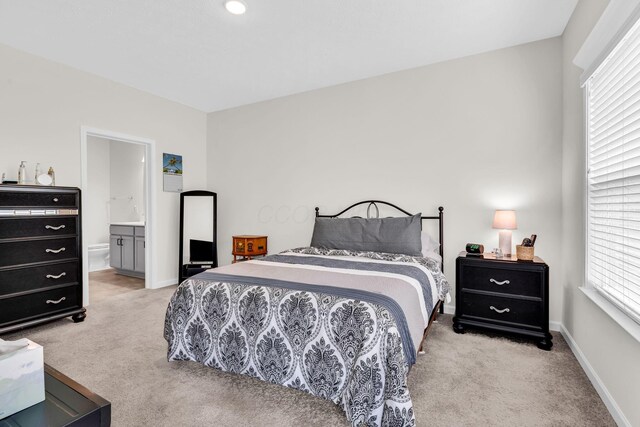 5837 Mouzon Dr, Columbus, OH 43232 - bedroom with ensuite bath, light carpet, and baseboards