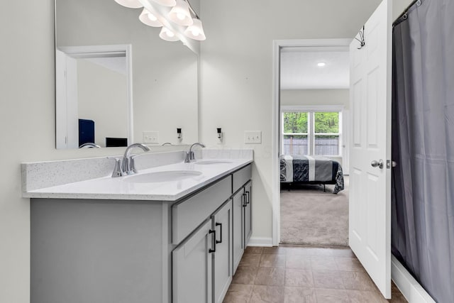 5837 Mouzon Dr, Columbus, OH 43232 - bathroom with double vanity, connected bathroom, baseboards, and a sink