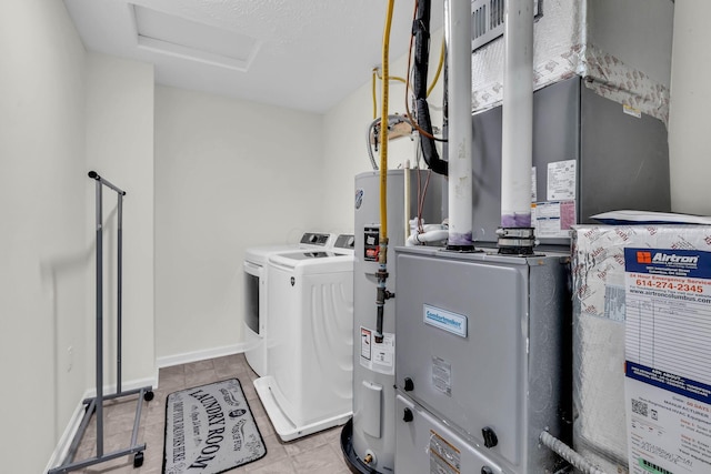 5837 Mouzon Dr, Columbus, OH 43232 - laundry area featuring laundry area, attic access, electric water heater, heating unit, and washing machine and dryer