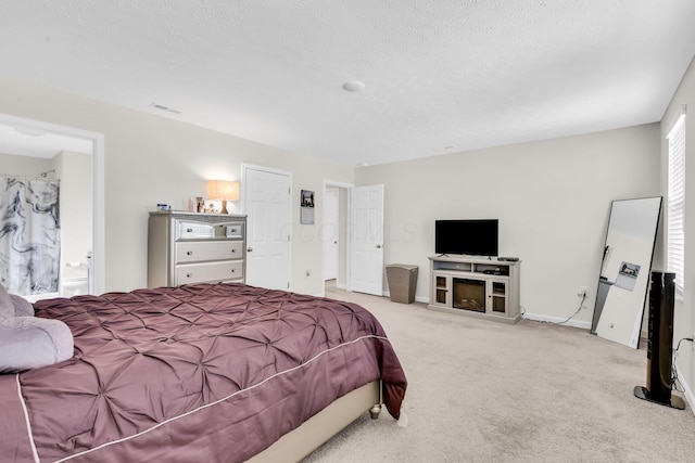 5837 Mouzon Dr, Columbus, OH 43232 - carpeted bedroom with a textured ceiling, connected bathroom, baseboards, and visible vents