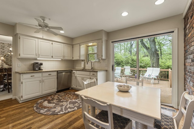 4522 Crompton Dr, Columbus, OH 43220 - kitchen with dishwasher, a sink, white cabinetry, dark wood-type flooring, and recessed lighting