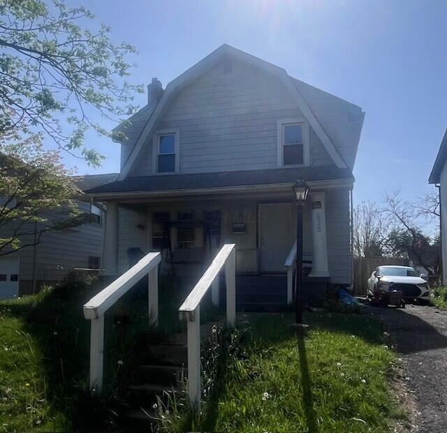 633 Wrexham Ave, Columbus, OH 43223 - view of front of home featuring covered porch, a chimney, and a gambrel roof