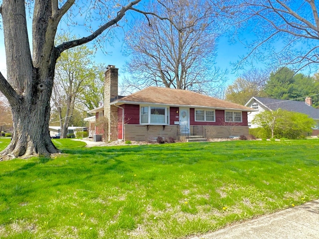 ranch-style home with a chimney and a front yard