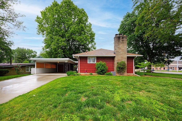 125 S Hamilton Rd, Columbus, OH 43230 - view of front of property featuring driveway, a front lawn, an attached carport, and a chimney