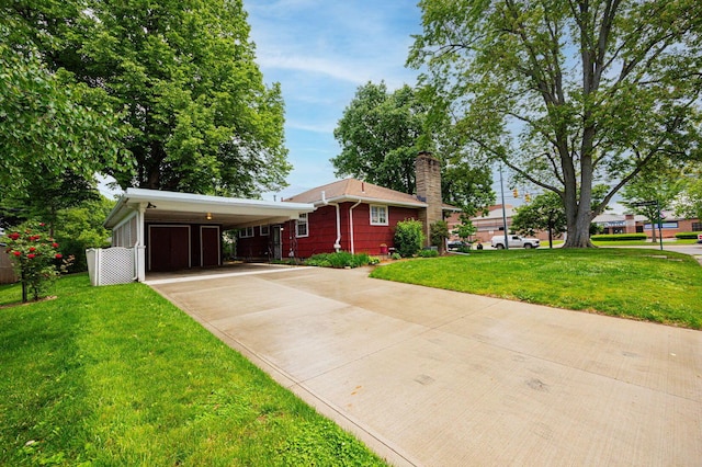 125 S Hamilton Rd, Columbus, OH 43230 - view of front of house featuring concrete driveway, a chimney, a front yard, and a carport