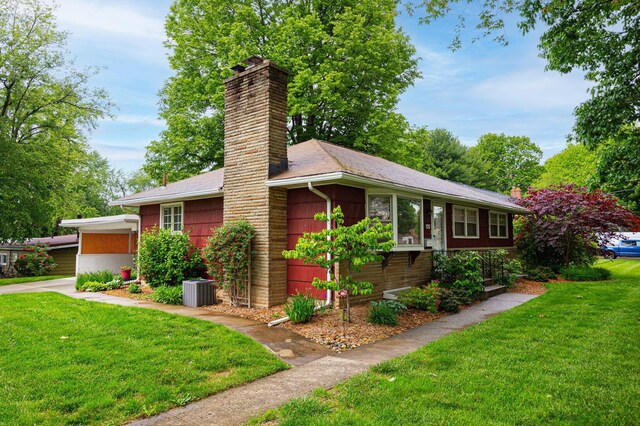 125 S Hamilton Rd, Columbus, OH 43230 - view of side of property with a chimney, a yard, and central AC