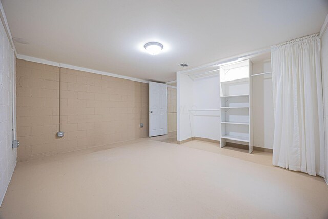 125 S Hamilton Rd, Columbus, OH 43230 - unfurnished bedroom featuring concrete block wall and a closet