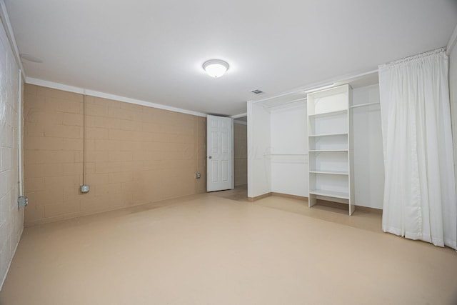 125 S Hamilton Rd, Columbus, OH 43230 - unfurnished bedroom featuring concrete block wall, finished concrete flooring, and a closet