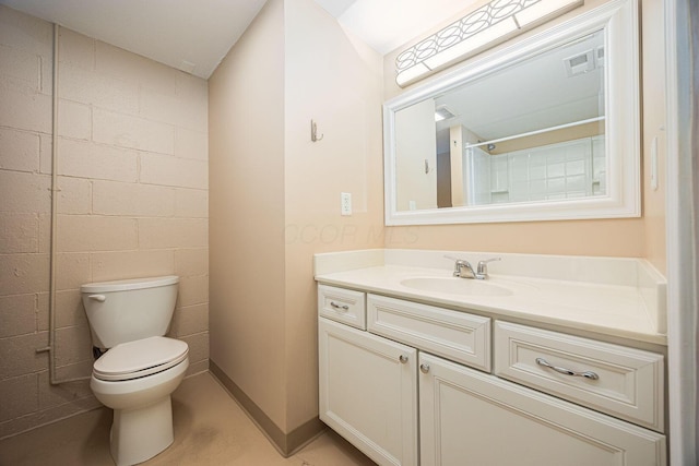 125 S Hamilton Rd, Columbus, OH 43230 - bathroom featuring vanity, toilet, and concrete block wall