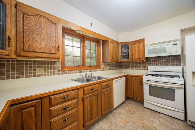 125 S Hamilton Rd, Columbus, OH 43230 - kitchen with white appliances, a sink, brown cabinets, light countertops, and backsplash